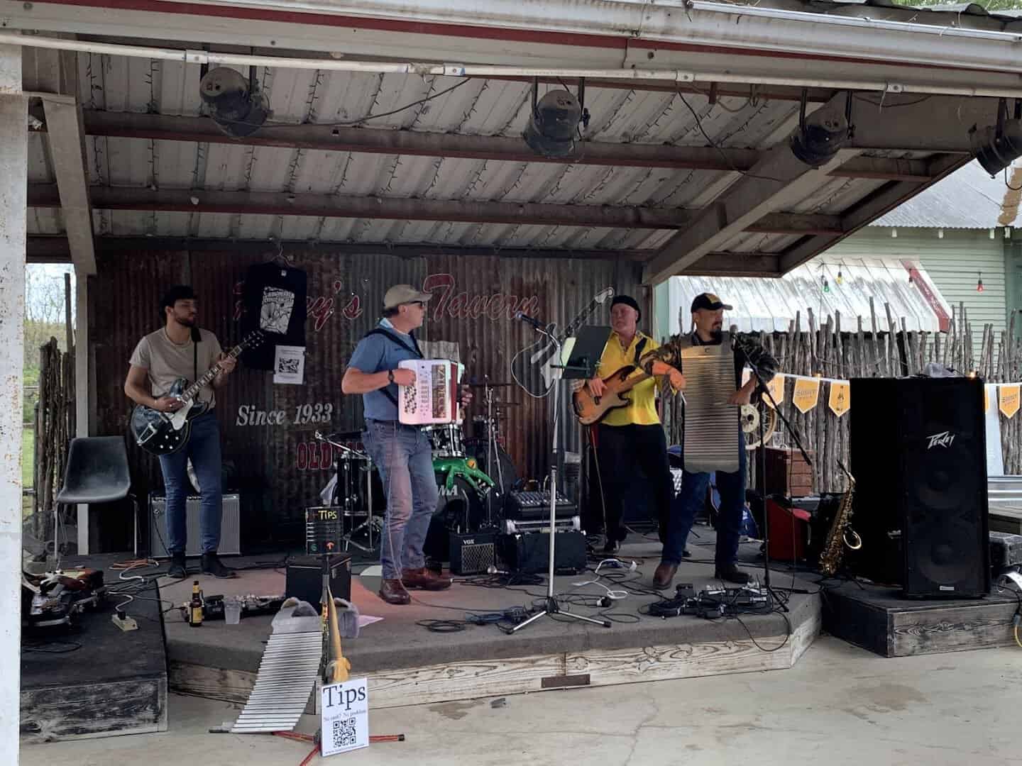 A full band playing live on stage at Riley's Tavern in Hunter, Texas