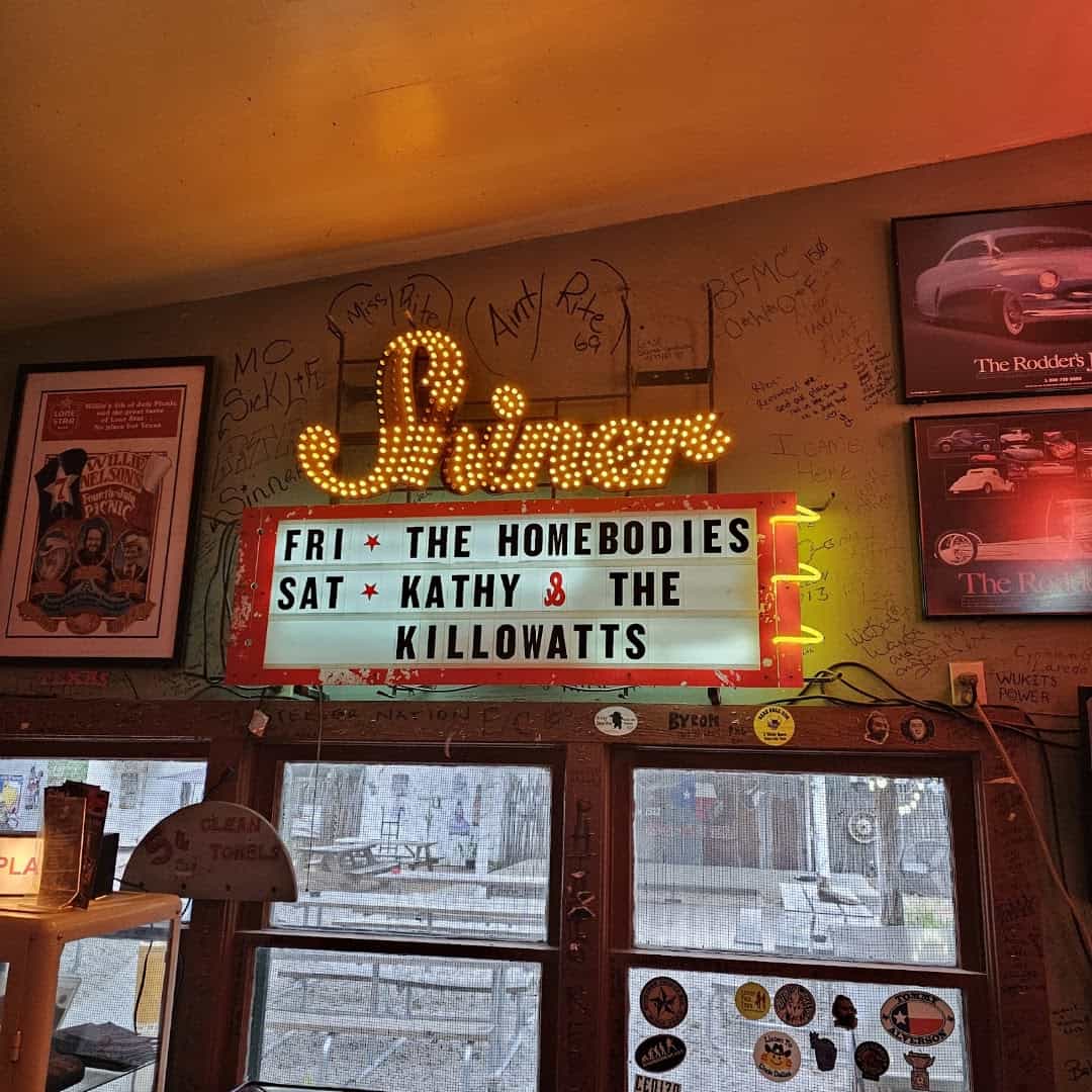 Walls covered in framed photos, posters and memorabilia inside Riley's Tavern in Hunter, Texas