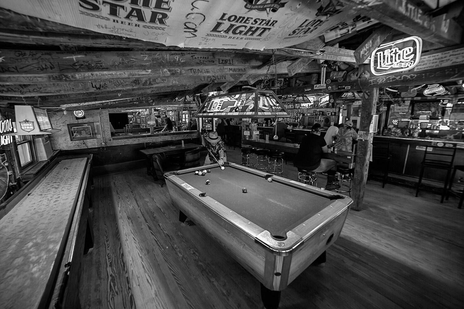 Pool tables and neon beer signs inside historic Riley's Tavern near New Braunfels, Texas