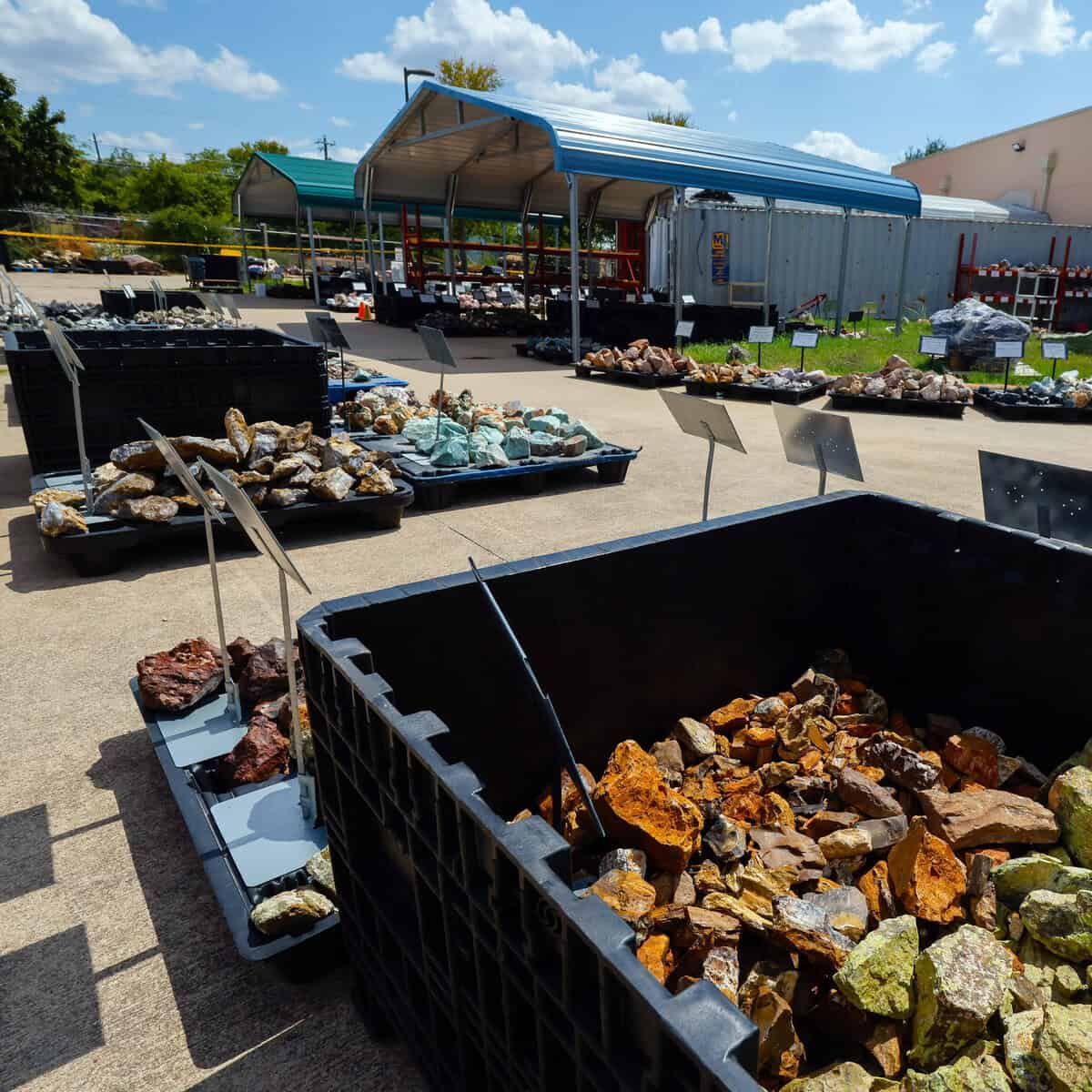 Bins of bulk rough rock in the outdoor Rock Yard at Nature's Treasures in Austin