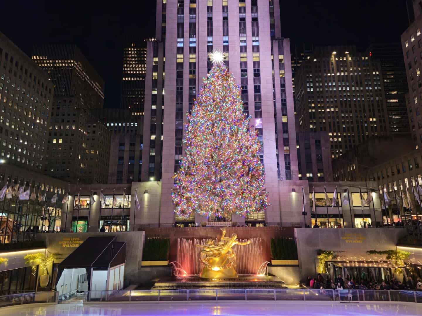 The lit Christmas tree and ice rink at Rockefeller Center, New York, New York