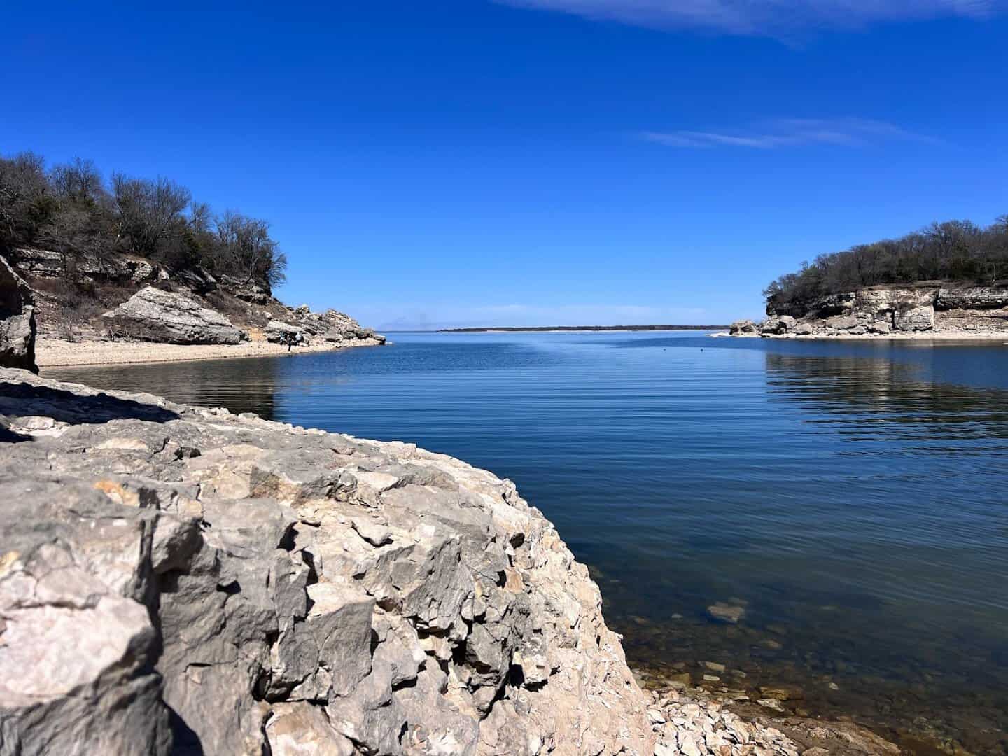 Rocky shoreline meeting blue water at Eisenhower State Park on Lake Texoma