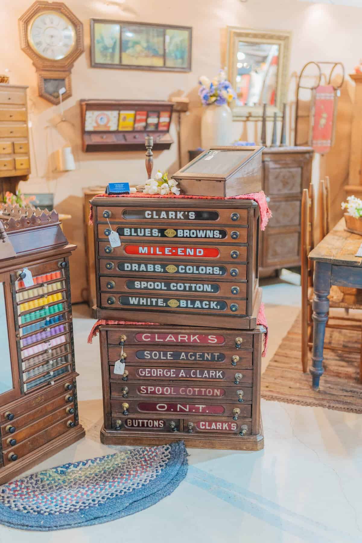 Antique labeled apothecary drawers and oak cabinets at the Round Top antiques fair