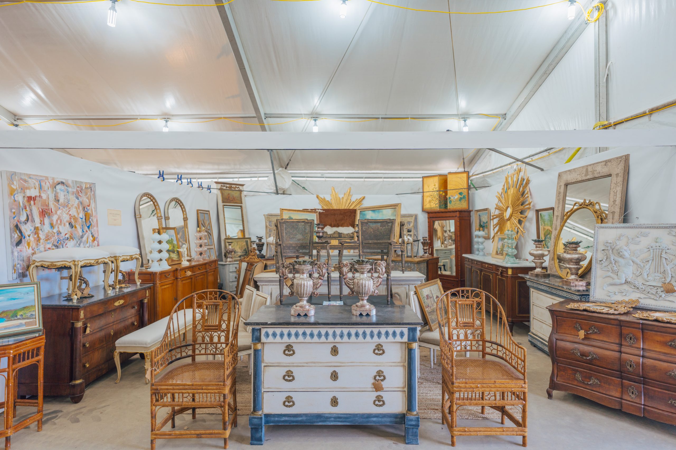 Antique dressers and mirrors displayed in a Round Top vendor booth
