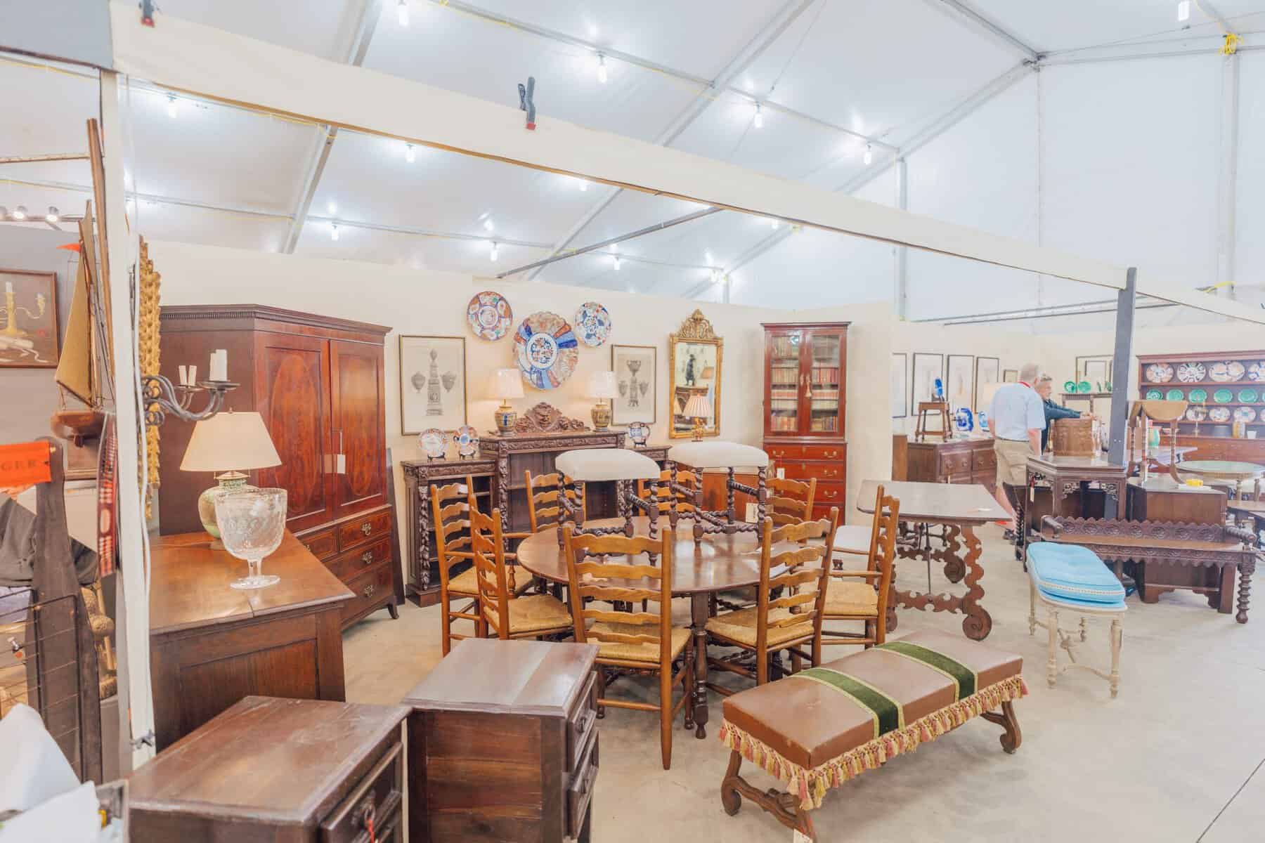 Rows of antique wooden furniture at the Original Round Top Antiques Fair