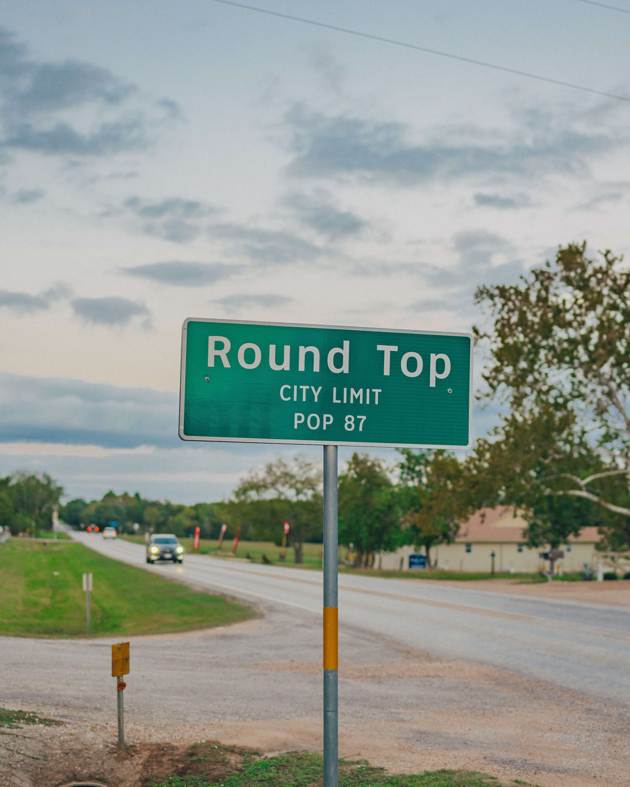 Round Top city limit sign, population 87, on the highway into town