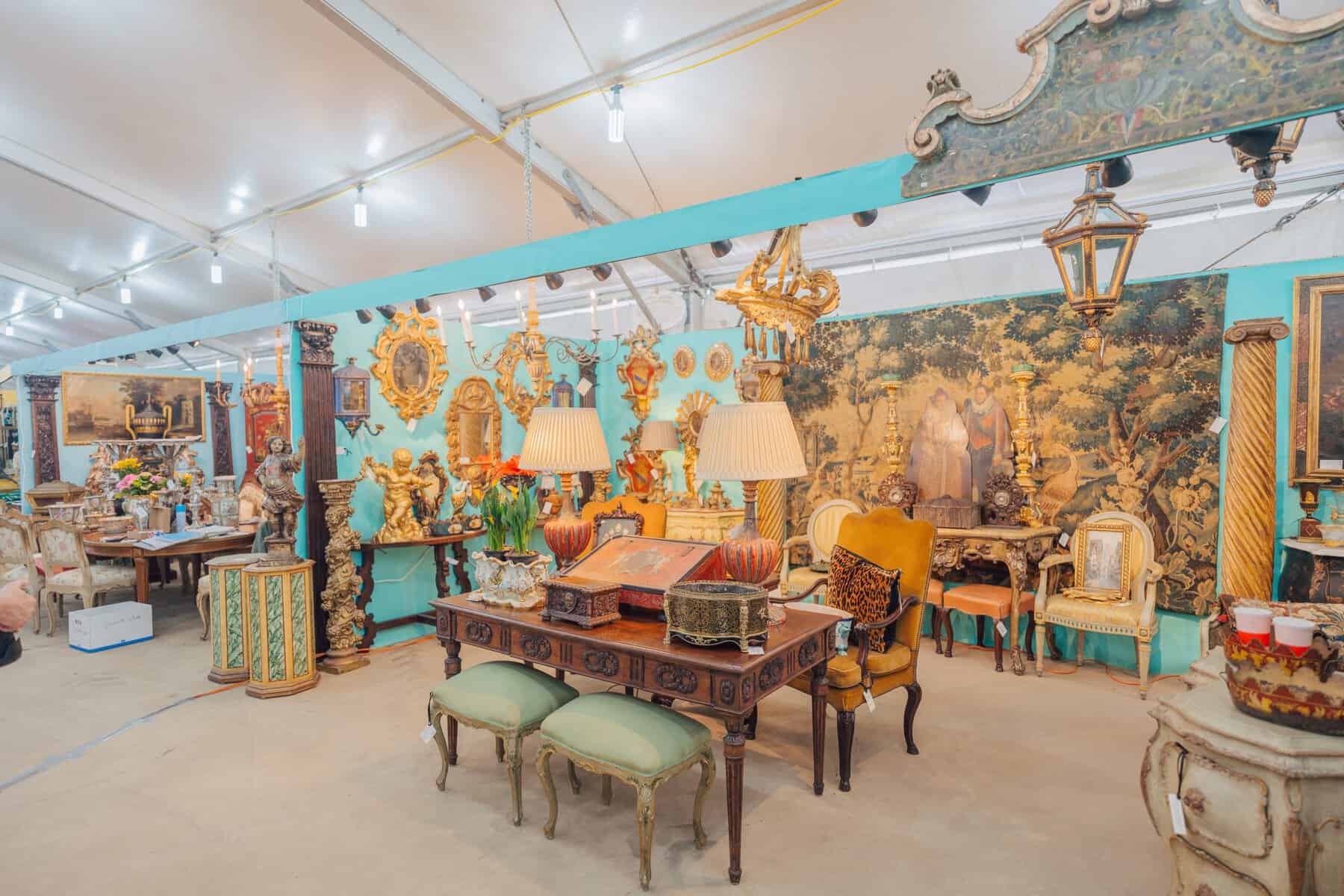 Colorful antique furniture booth vignette at the Round Top antiques fair in Texas