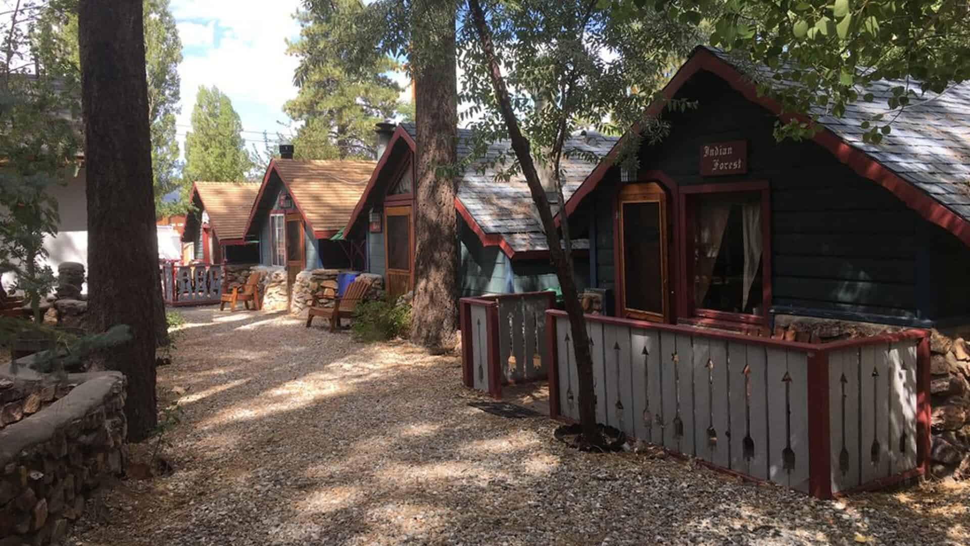 A row of storybook themed cottages among the pines at Castle Wood Cottages, Big Bear Lake, California