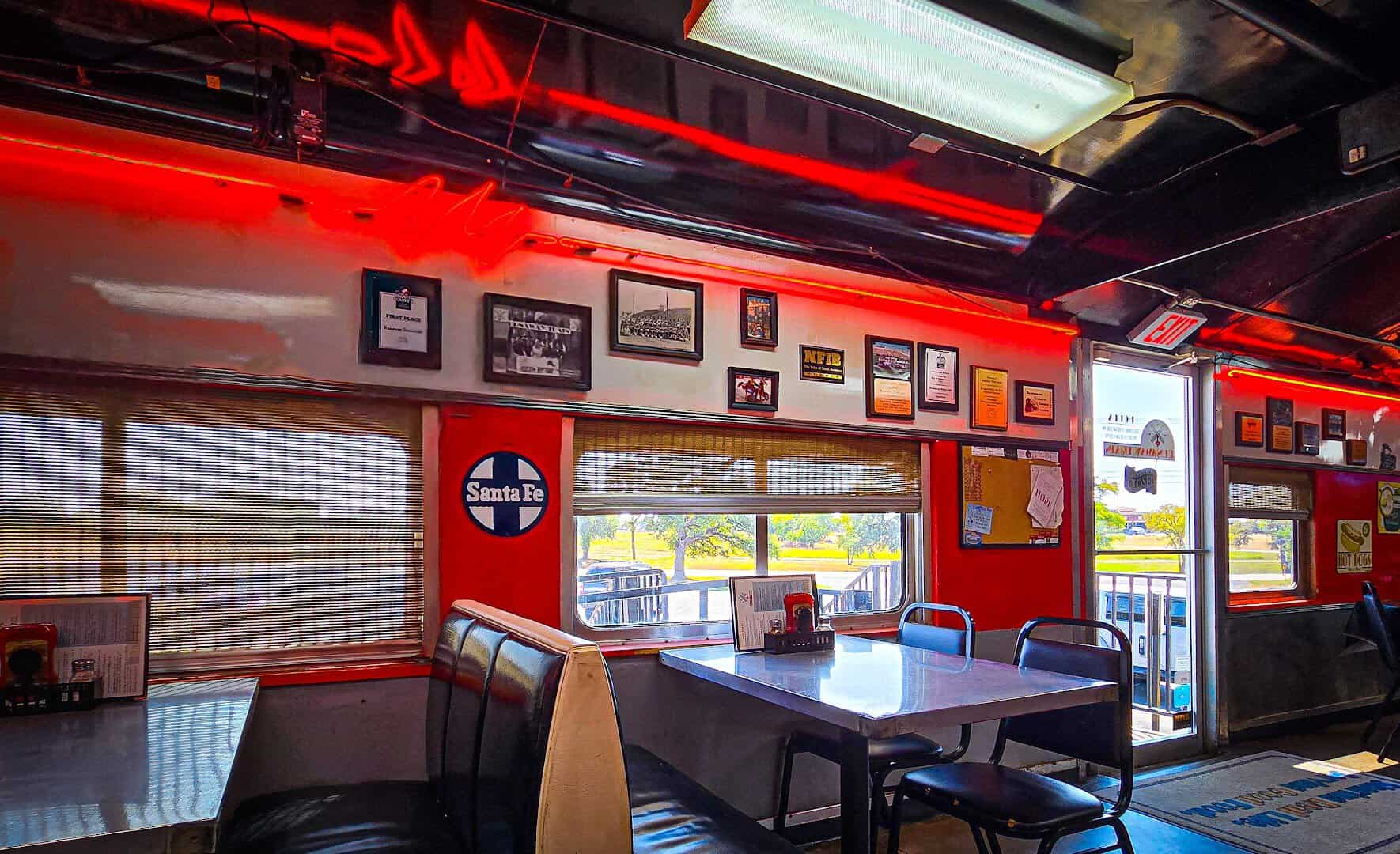 Booth and Santa Fe railroad photos inside the Runaway Train Cafe train car