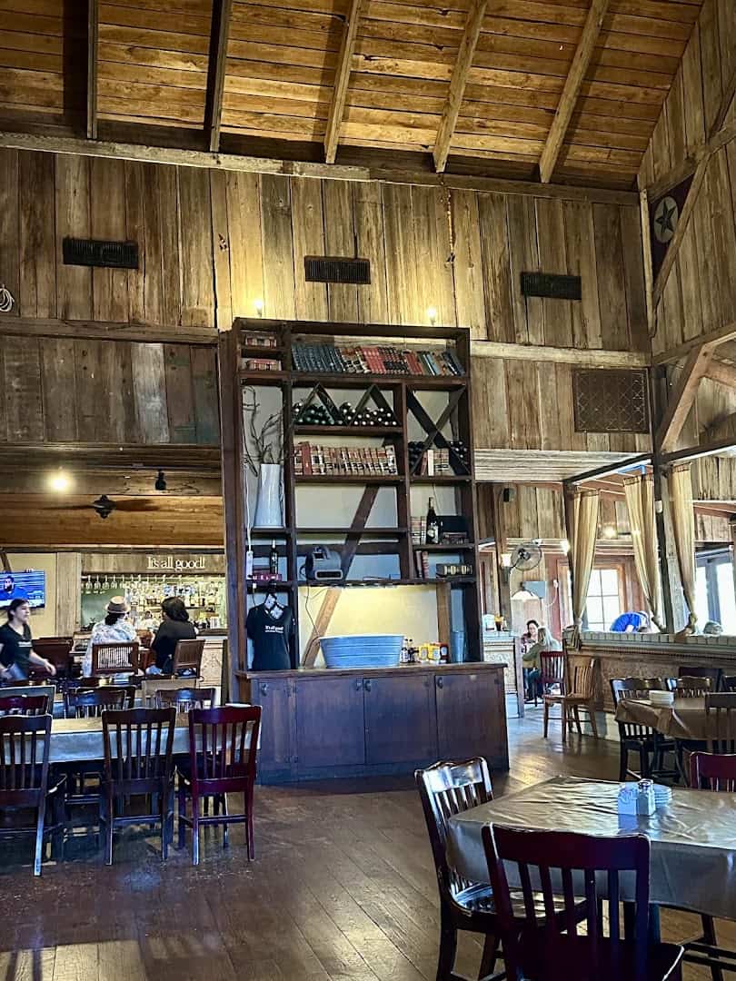 Rustic dining room with timber beams at Gruene River Grill in New Braunfels