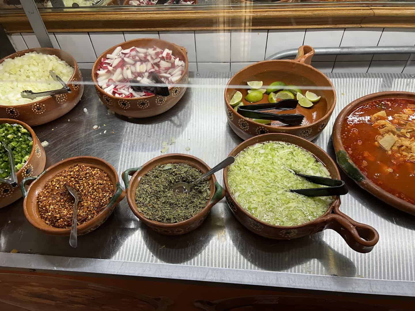 House-made salsas and guisados in molcajetes at Ranchero King Buffet in Houston