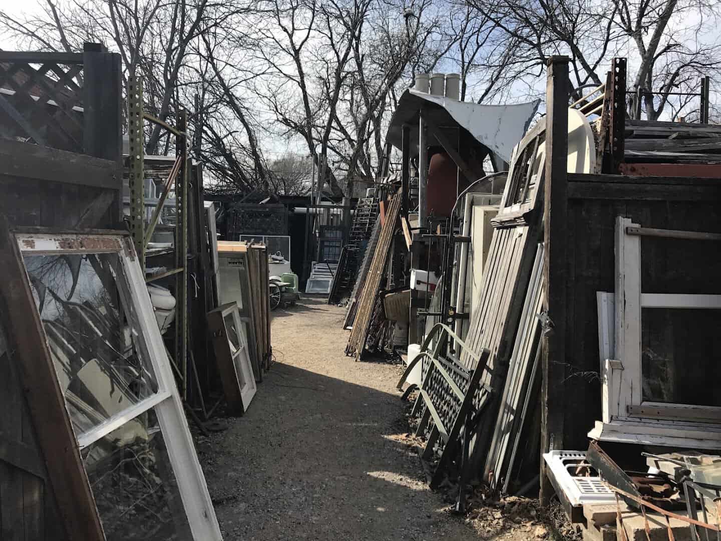Rows of salvaged doors and old windows in the outdoor yard at Old Home Supply House in Fort Worth