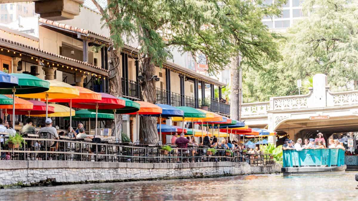 The San Antonio River Walk lined with colorful patio umbrellas, San Antonio, Texas