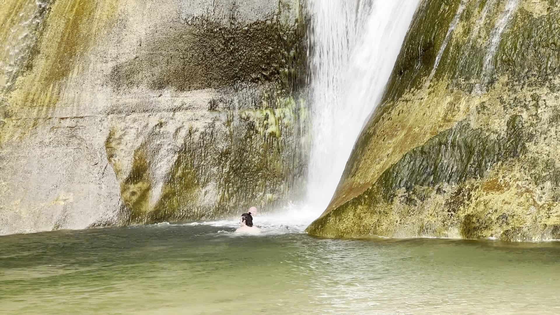 Lower Calf Creek Falls dropping down a sandstone wall into a creek off Scenic Byway 12 near Escalante, Utah