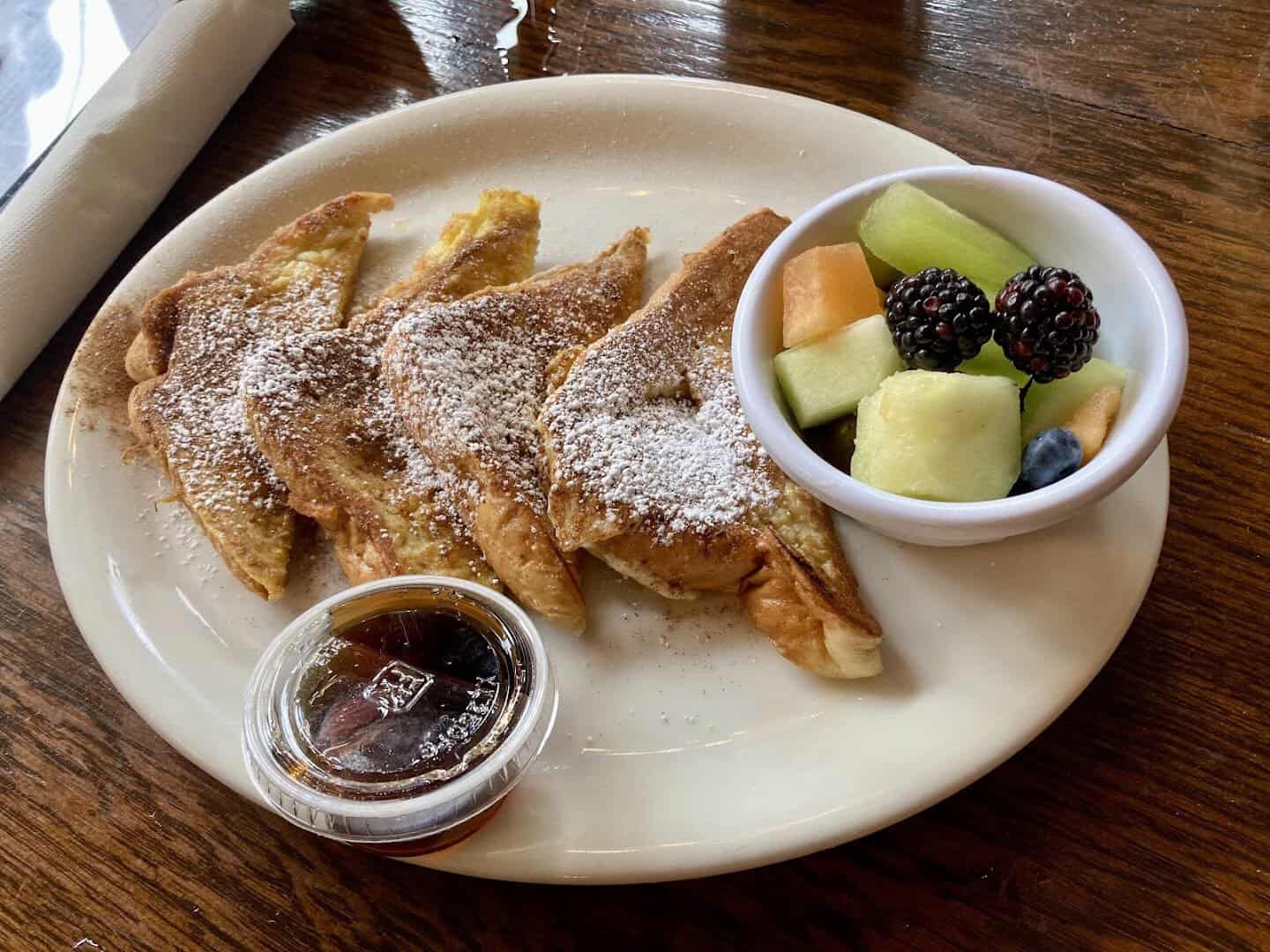 French toast with powdered sugar and fresh fruit at Schilo's in San Antonio