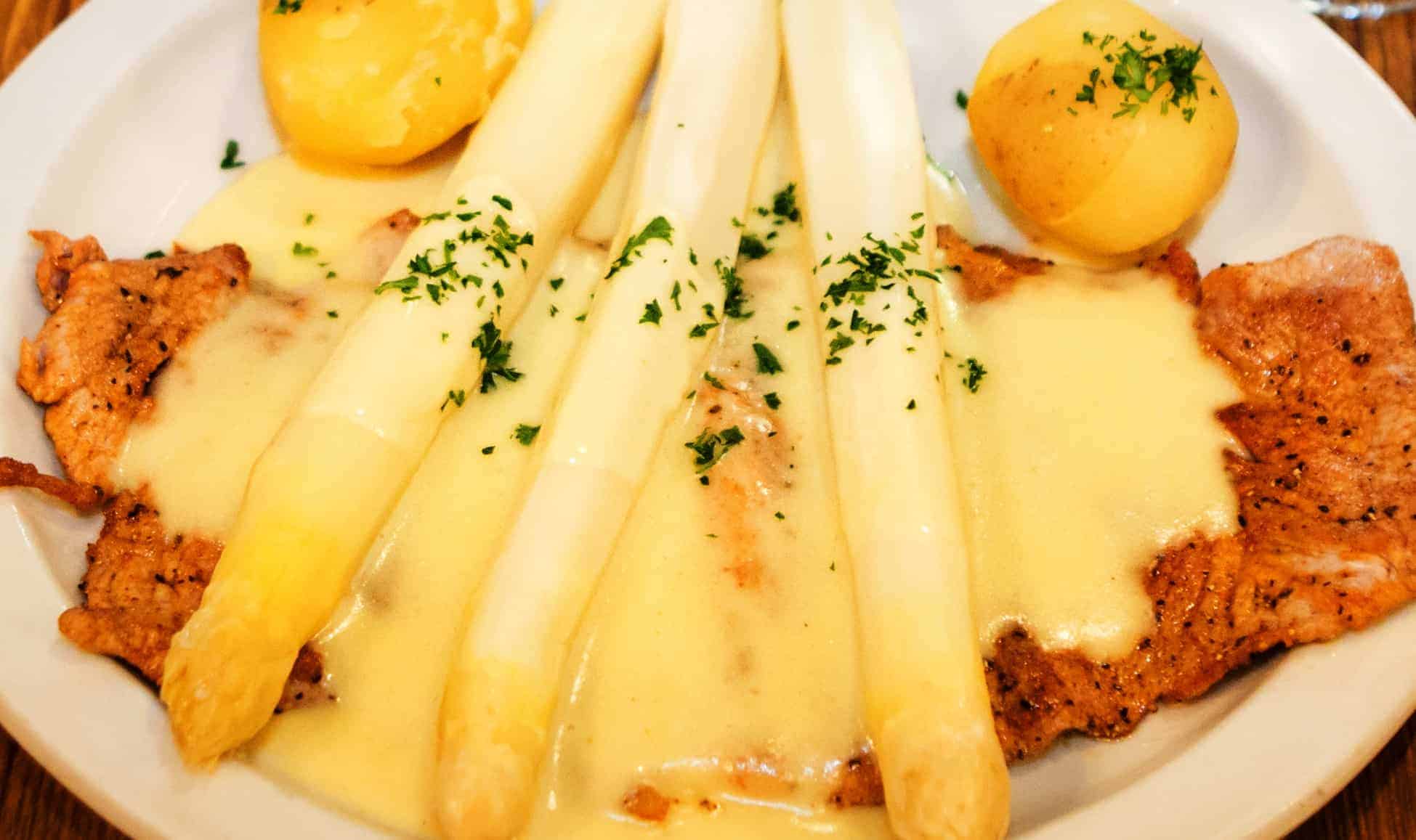 Pork schnitzel topped with white asparagus and cream sauce at Bavarian Grill in Plano