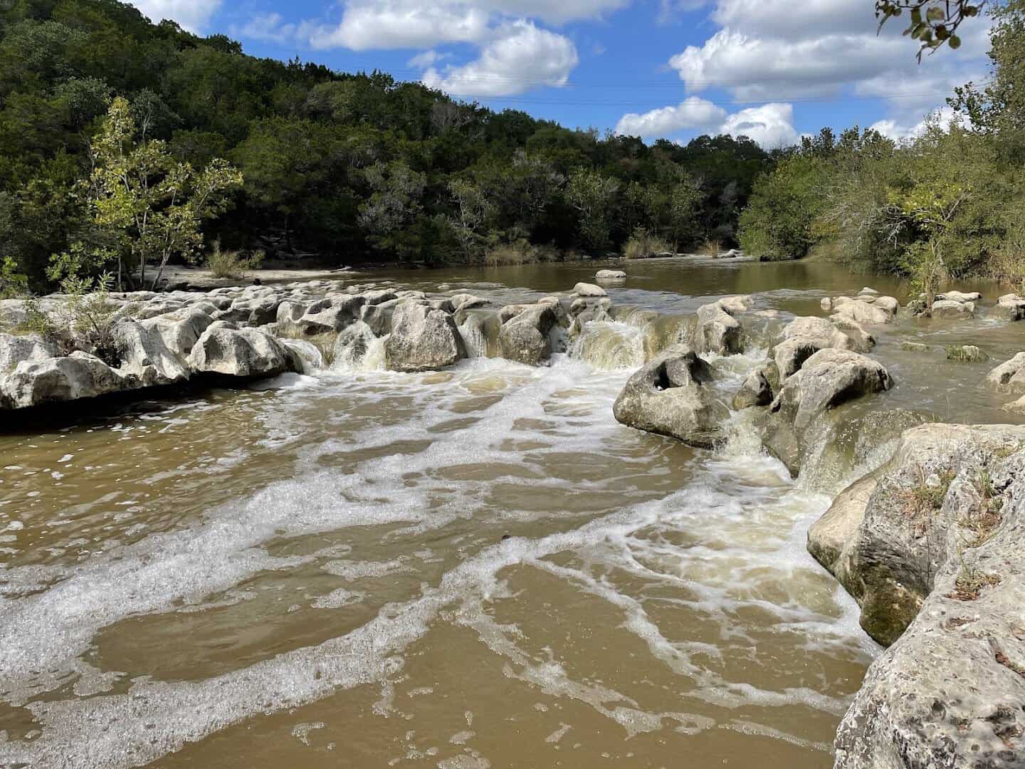 Water sliding over sculpted limestone at Sculpture Falls on the Barton Creek Greenbelt, Austin, Texas