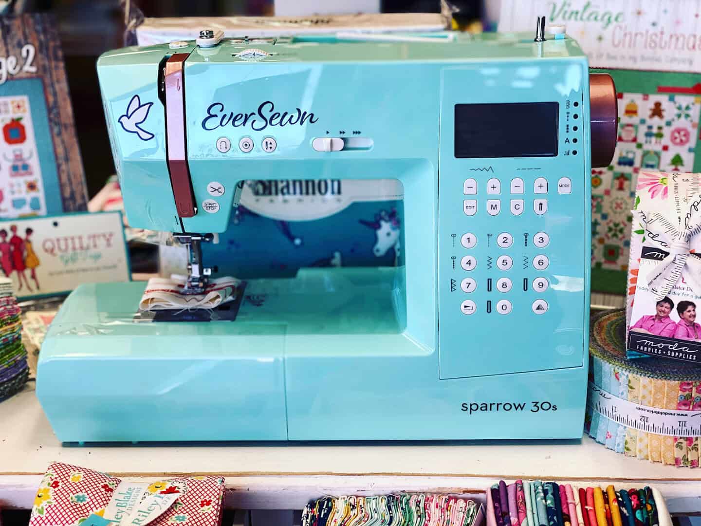 A sewing machine set up on a table at The Sparkly Elephant Sewing Lounge in Friendswood, Texas