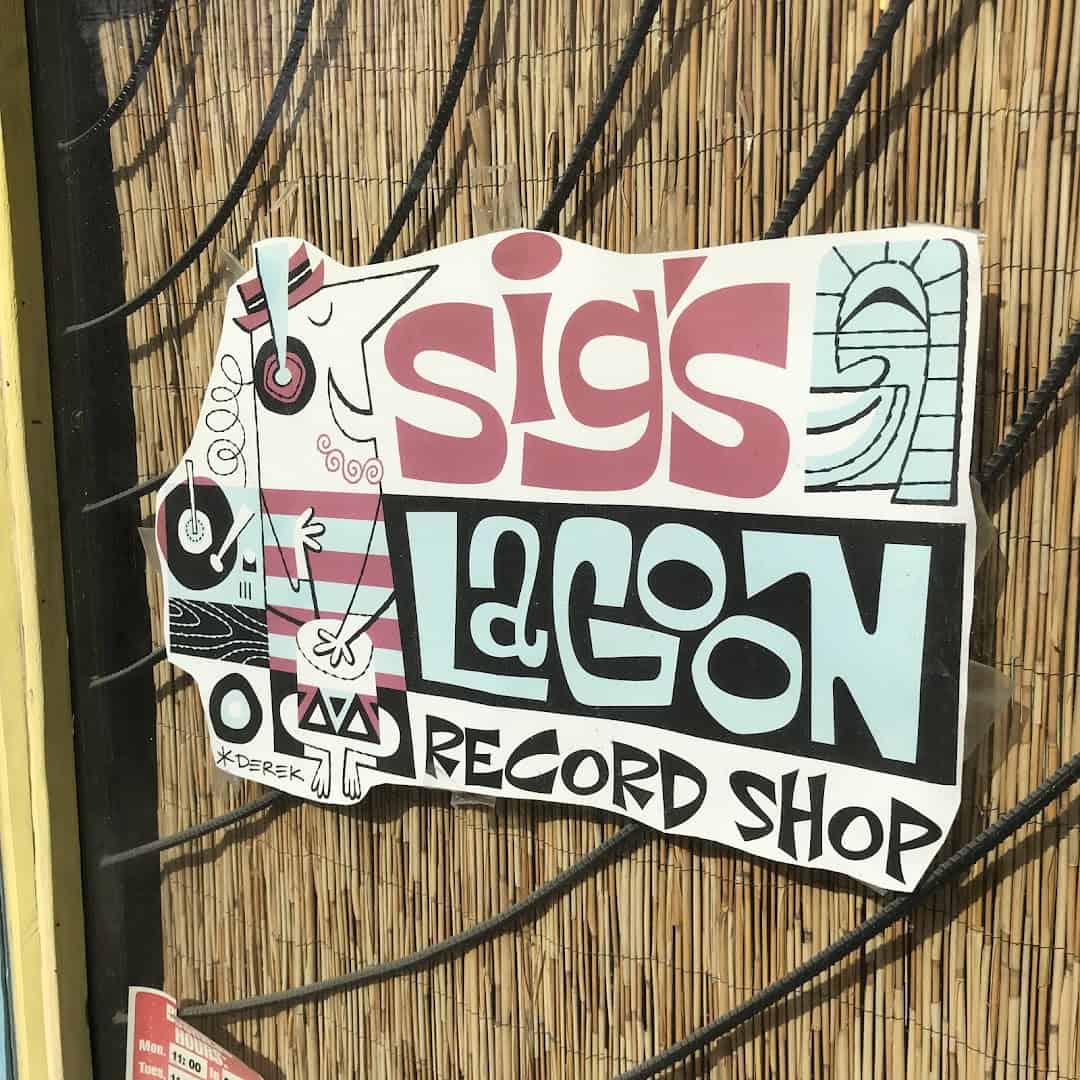 Sigs Lagoon Record Shop sign on the bamboo wall in Houston