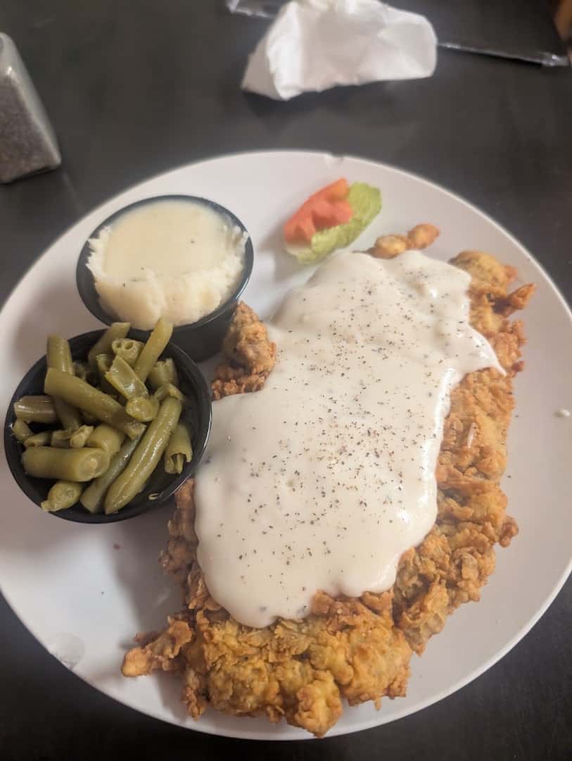 Chicken fried steak smothered in peppered cream gravy with green beans and mashed potatoes at Skeet's Texas Grill in Sweetwater, Texas
