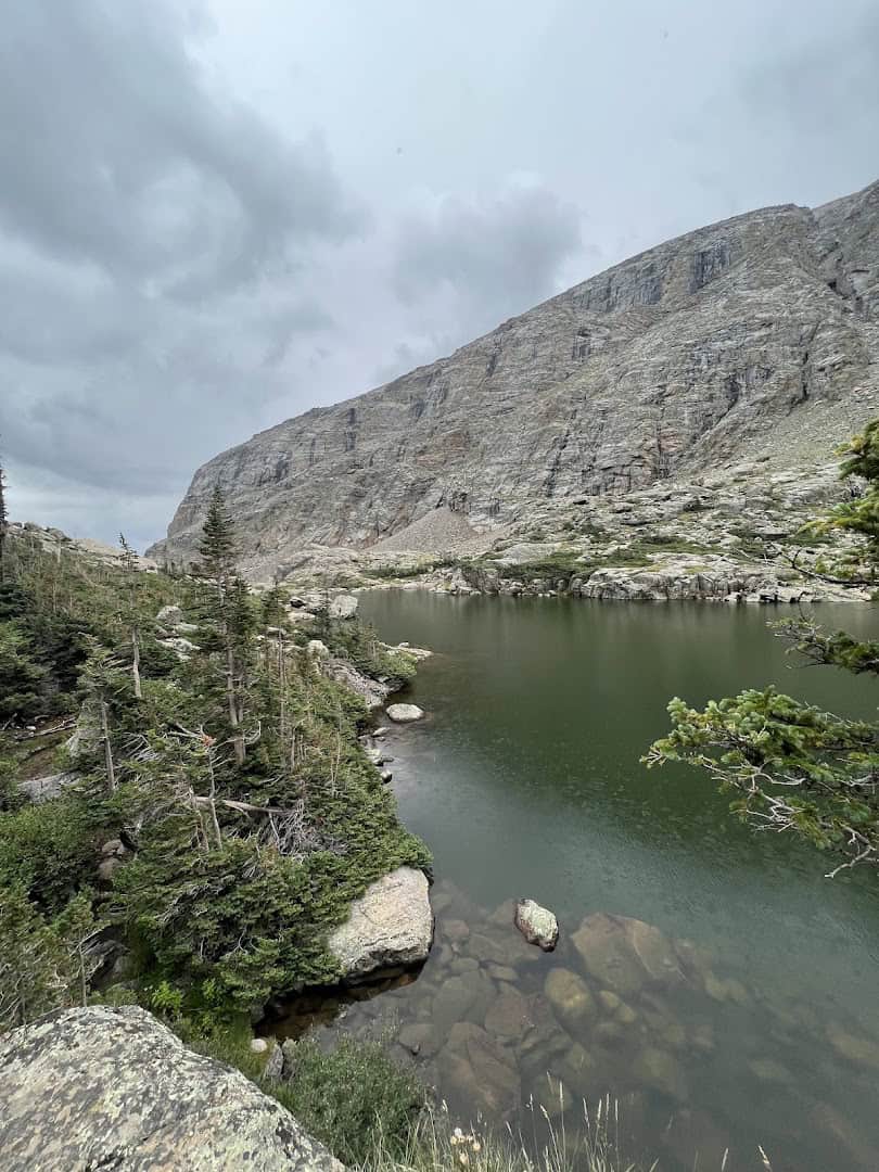 Alpine lake below the Sharkstooth spires at Sky Pond, Colorado