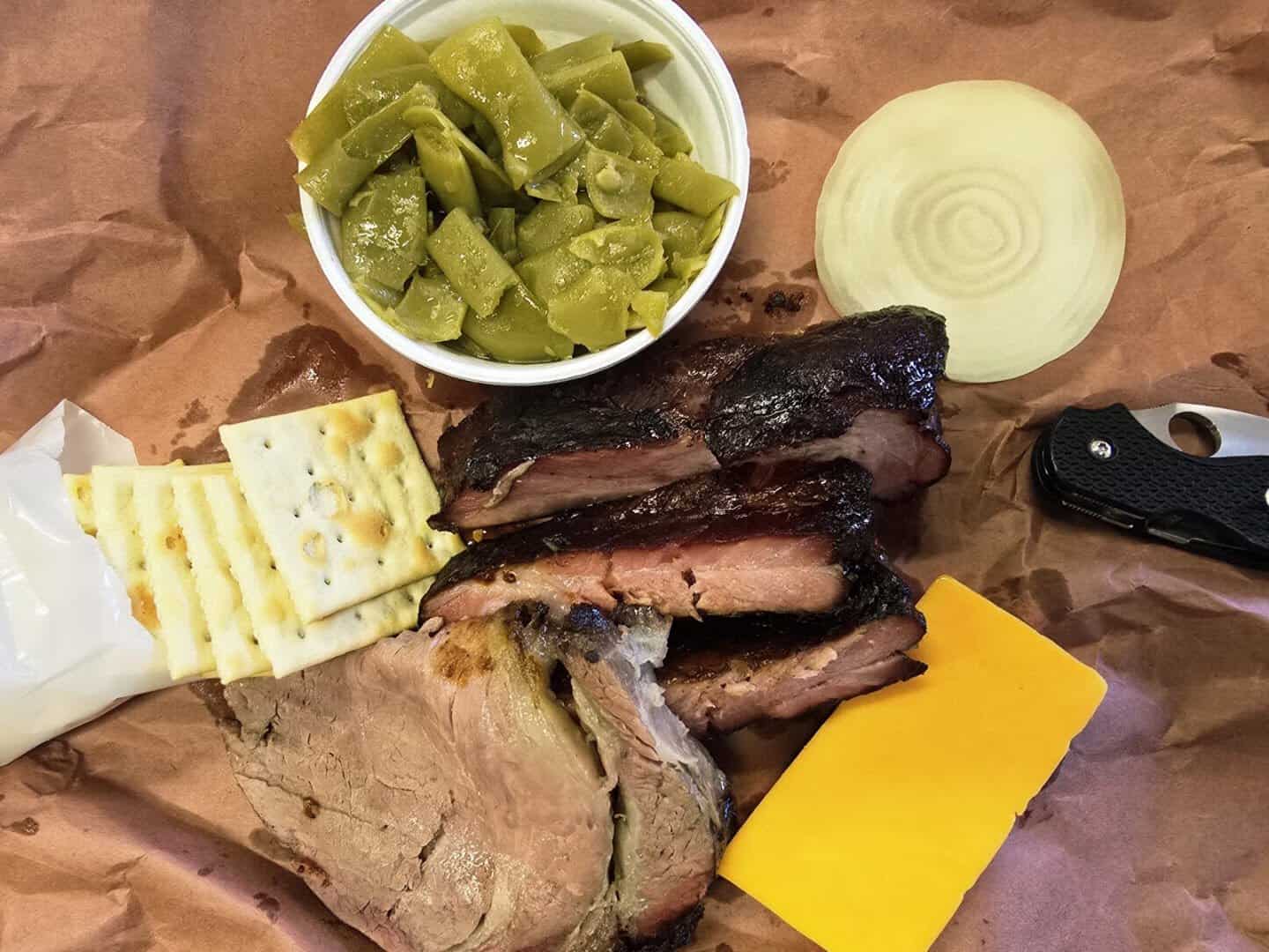 Smoked ribs, brisket, saltine crackers, cheese and onion on butcher paper at Smitty's Market in Lockhart, Texas