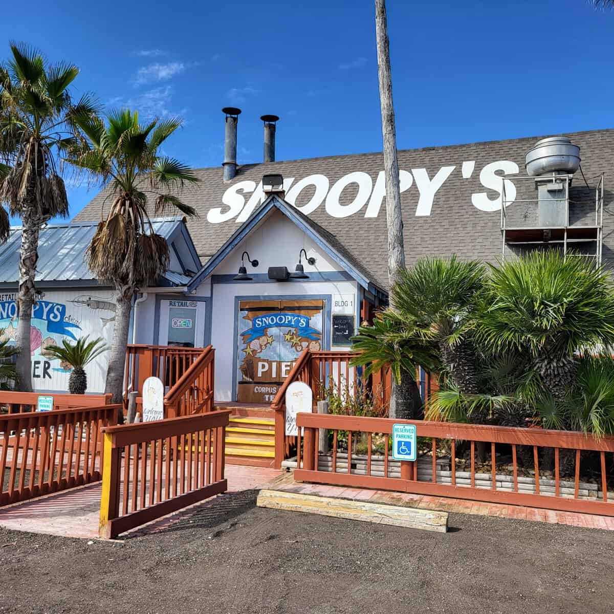 The Snoopy's Pier building and sign in Corpus Christi
