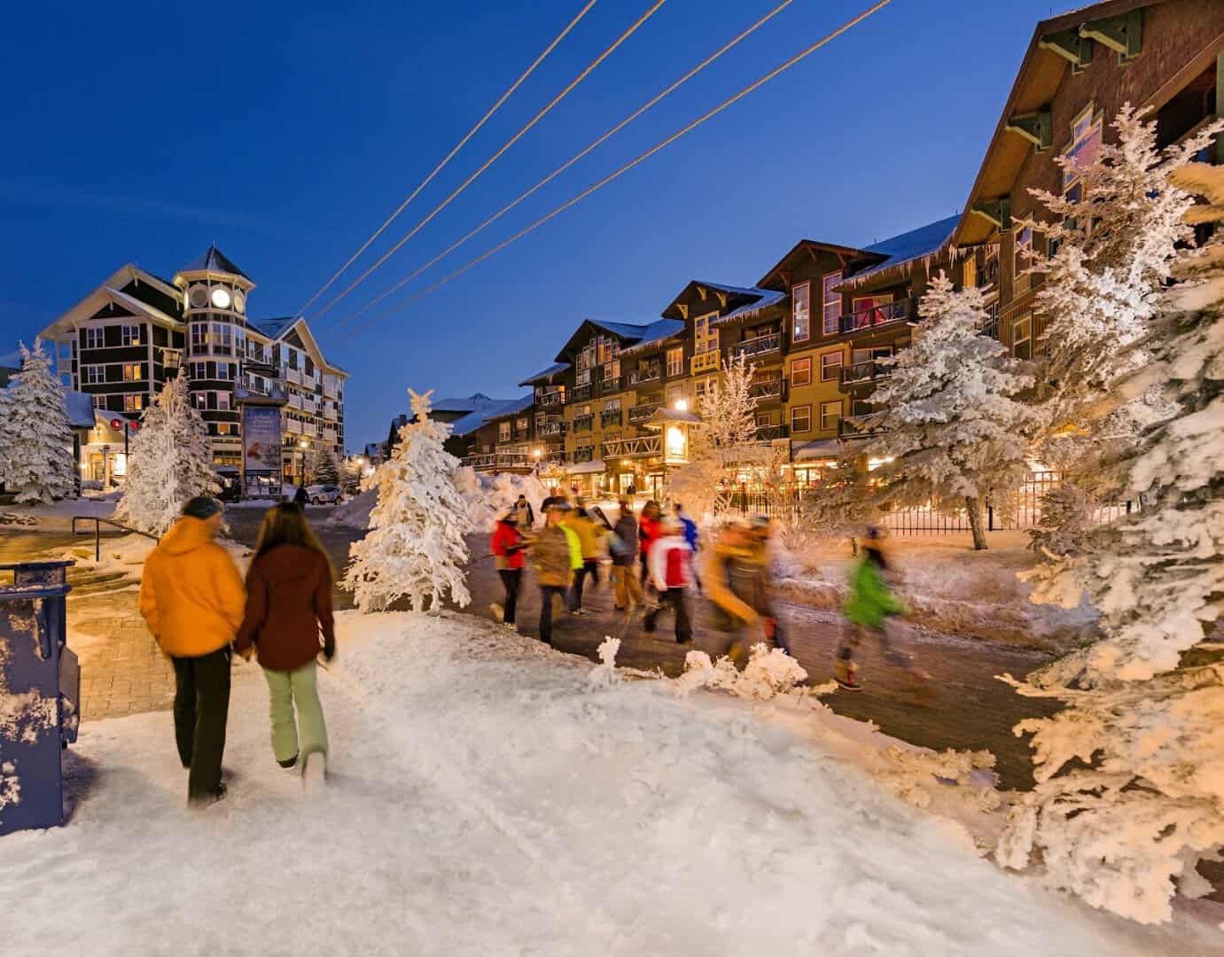 Snow-covered village with lit trees at dusk, Snowshoe Mountain Resort, West Virginia