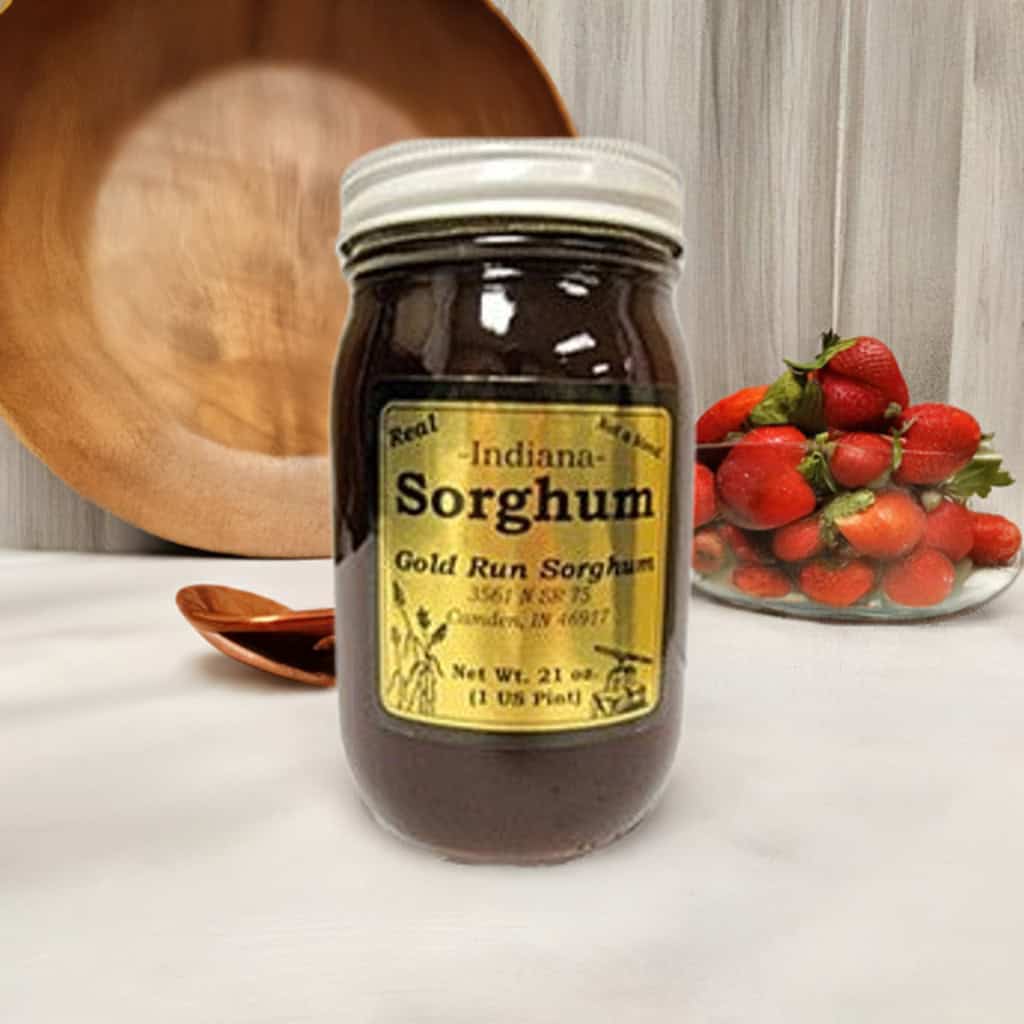 Jar of old-fashioned sorghum with fresh strawberries at Veal Station Amish Market