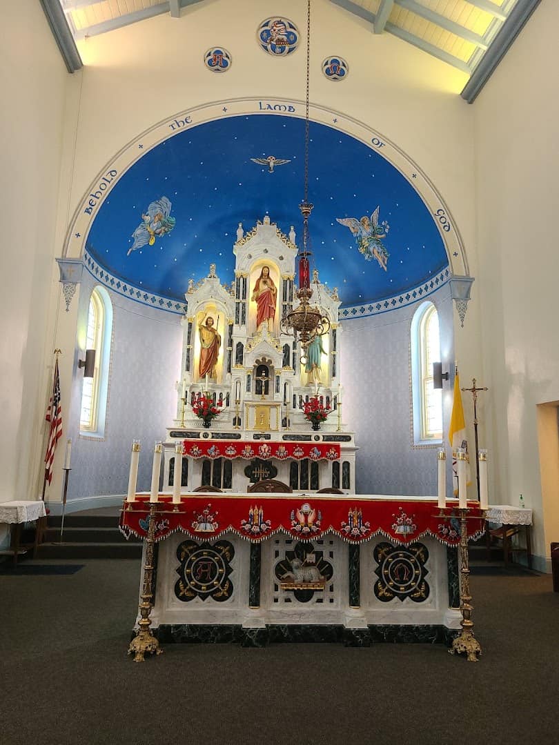 Main altar under the painted blue apse arch at St. Anthony Catholic Church in Bryan