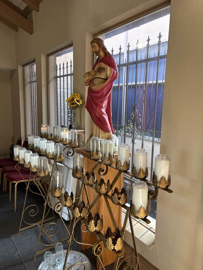 Sacred Heart statue beside a candle shrine at St. Anthony Catholic Church in Bryan