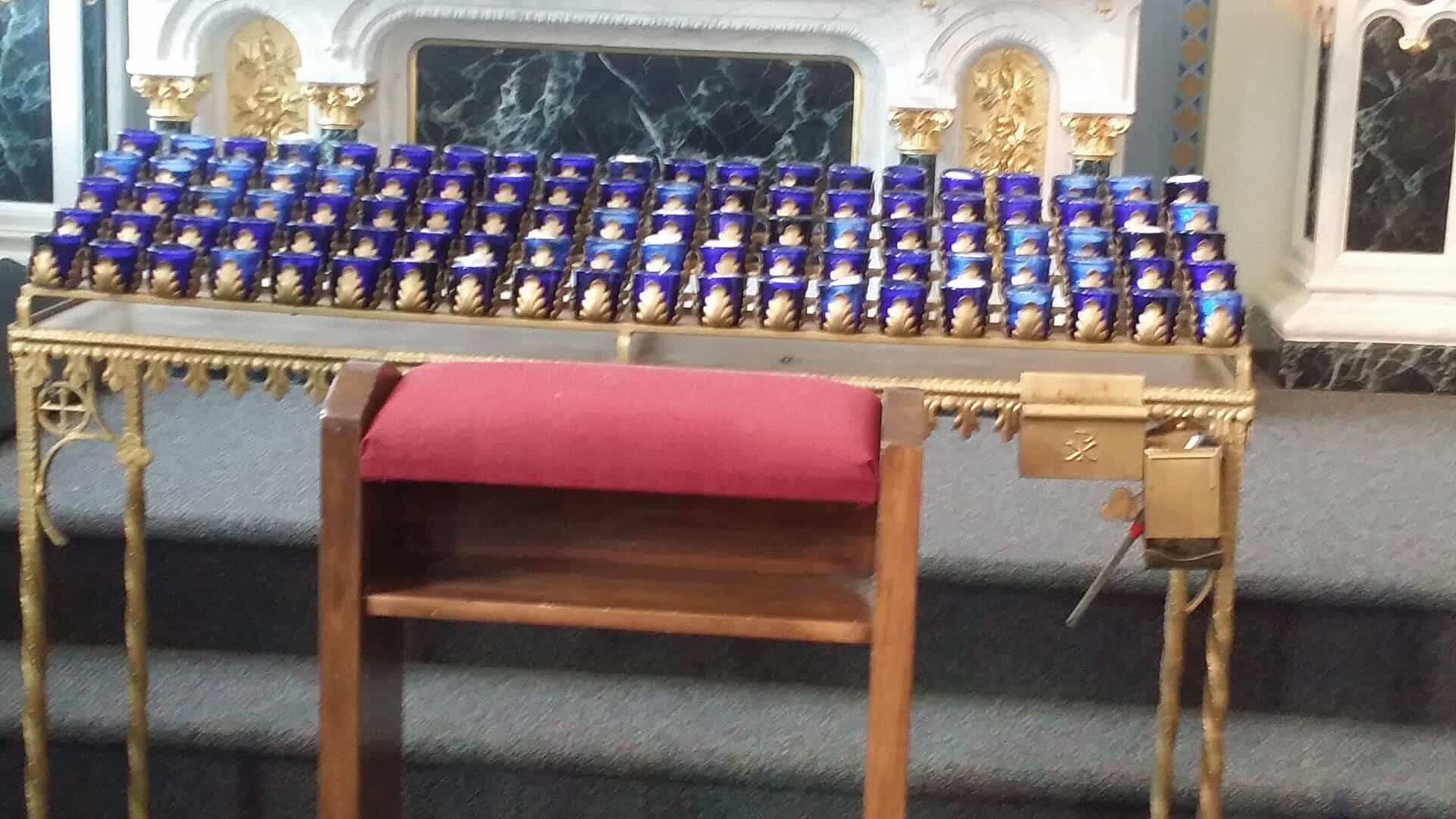 Rows of blue votive candles at St. Anthony Catholic Church in Bryan