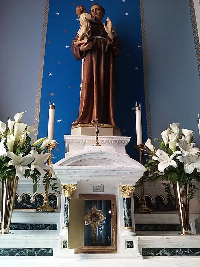 Statue of St. Anthony of Padua with lilies inside St. Anthony Catholic Church in Bryan