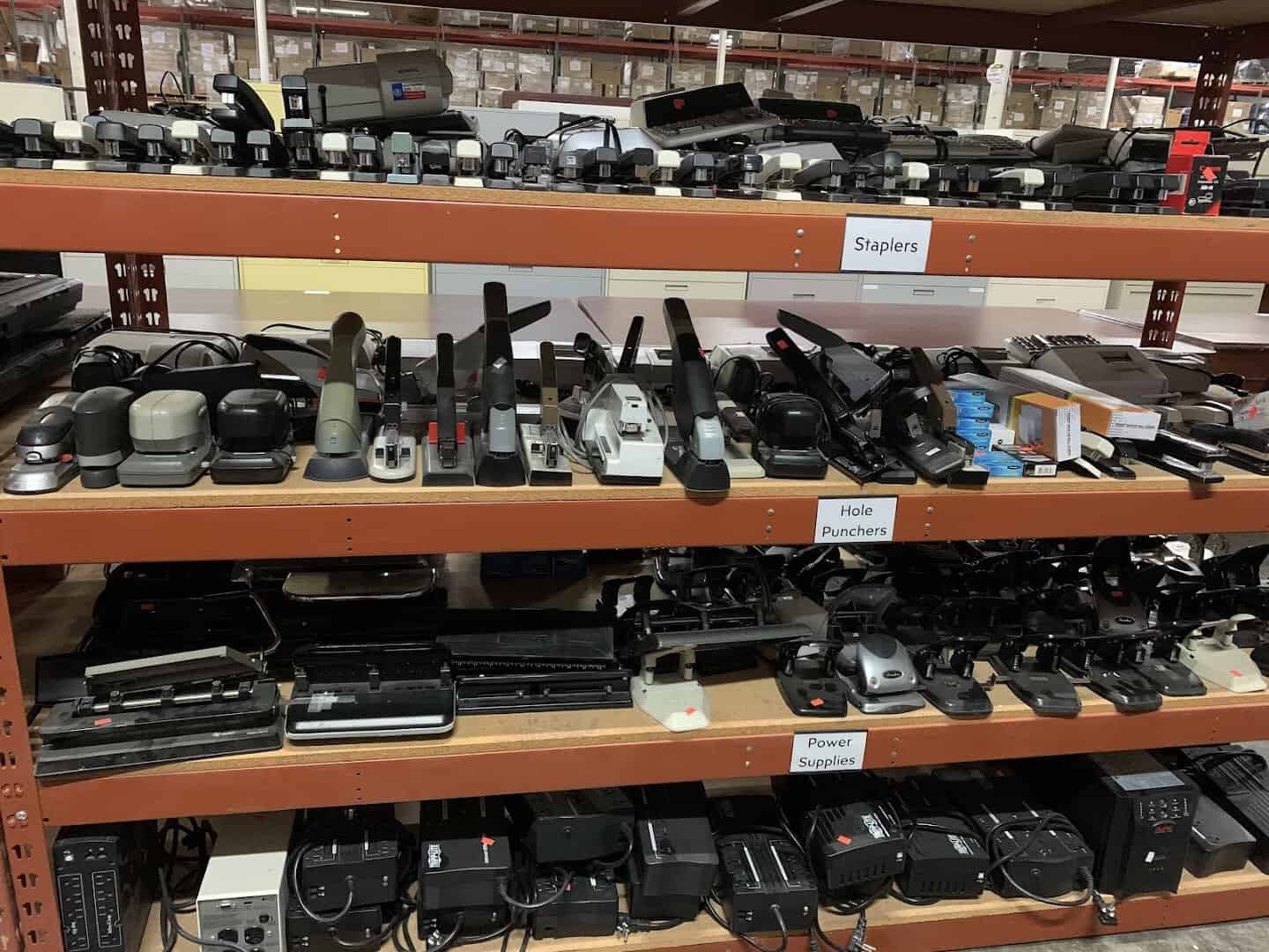 Shelves of surplus staplers, hole punchers and power supplies at the State Surplus Store in Austin