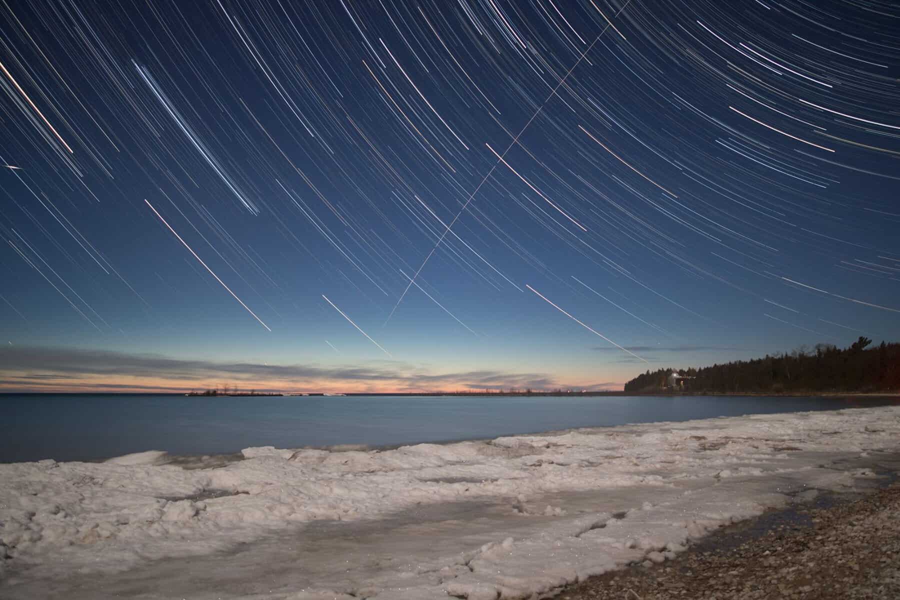 Star trails over the Lake Michigan shore at Headlands International Dark Sky Park, Michigan
