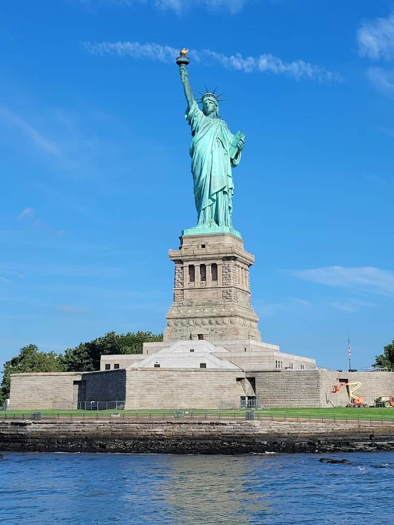 The Statue of Liberty rising over New York Harbor, New York