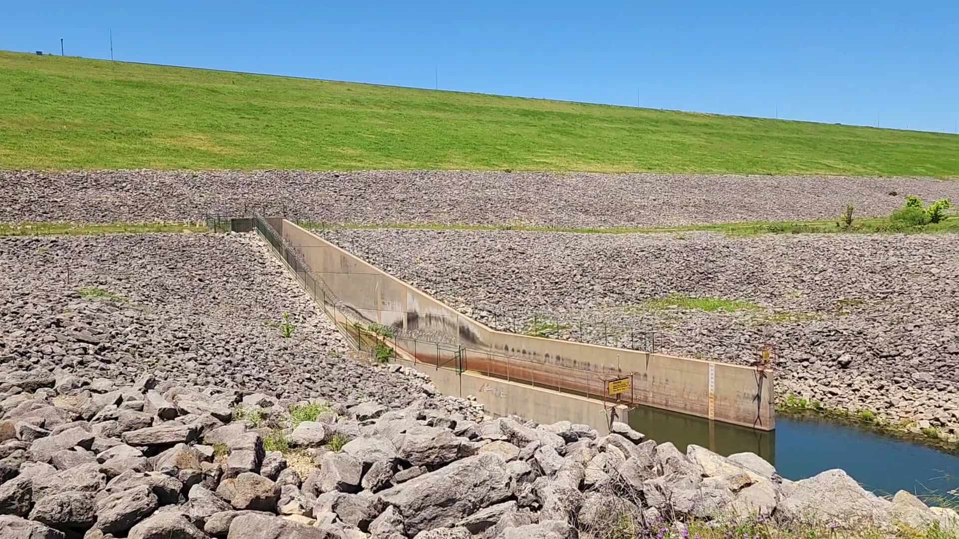 The rock-faced Stillhouse Hollow Dam and spillway above Chalk Ridge Falls Park near Belton, Texas