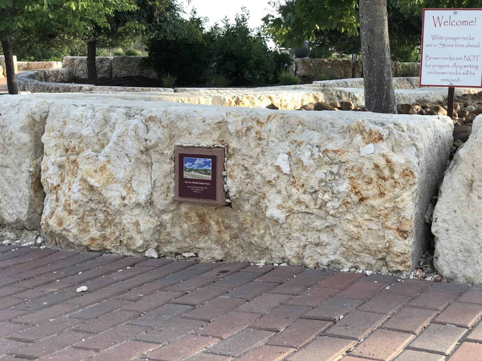 Stone entry wall and brick walkway at the Coming King Sculpture Prayer Garden in Kerrville
