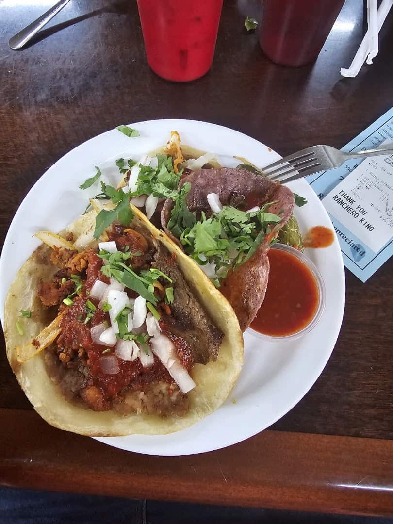 Street tacos topped with cilantro and onion at Ranchero King Buffet in Houston