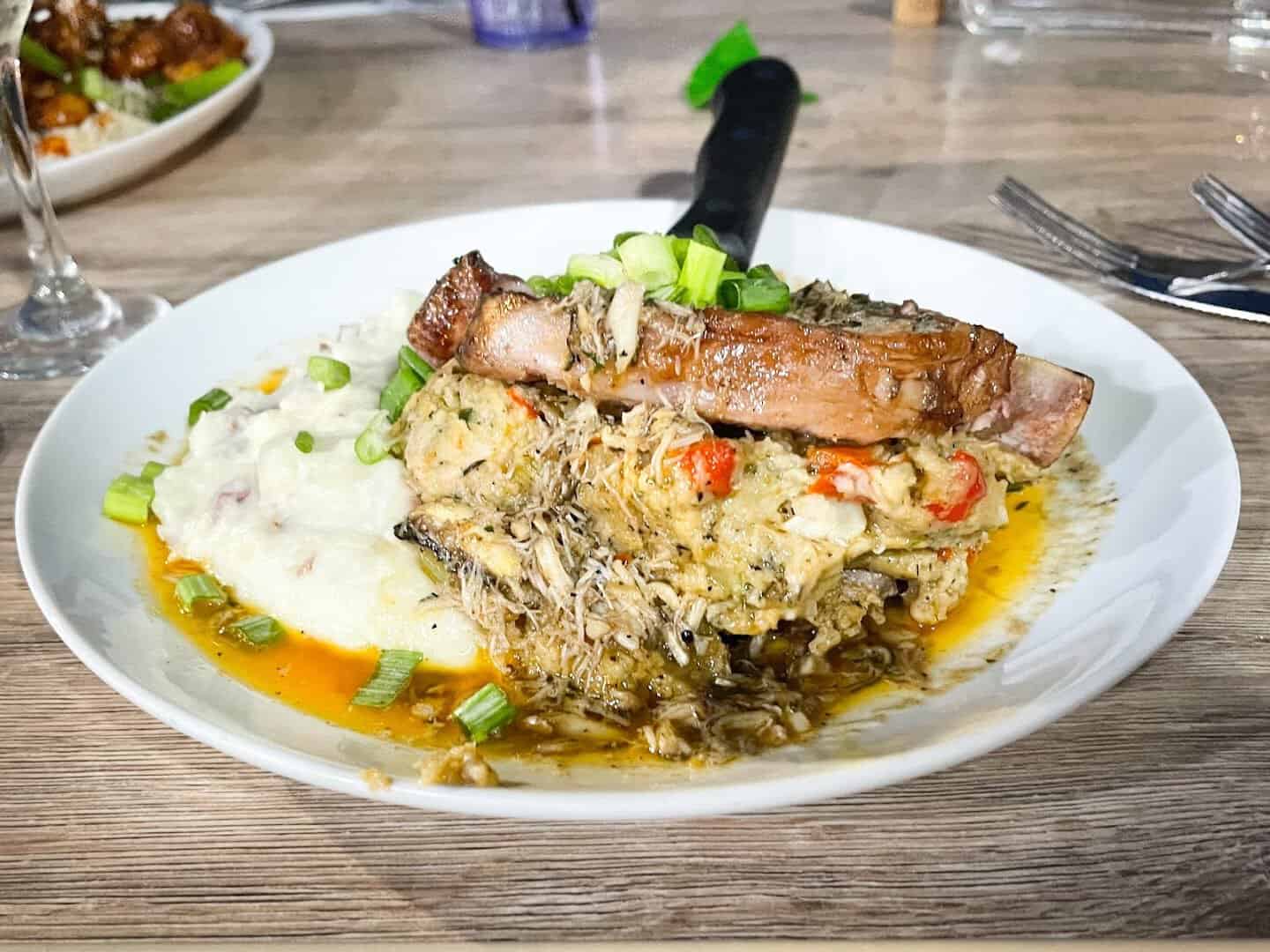 Grilled fish topped with crab over mashed potatoes at Katie's Seafood House in Galveston