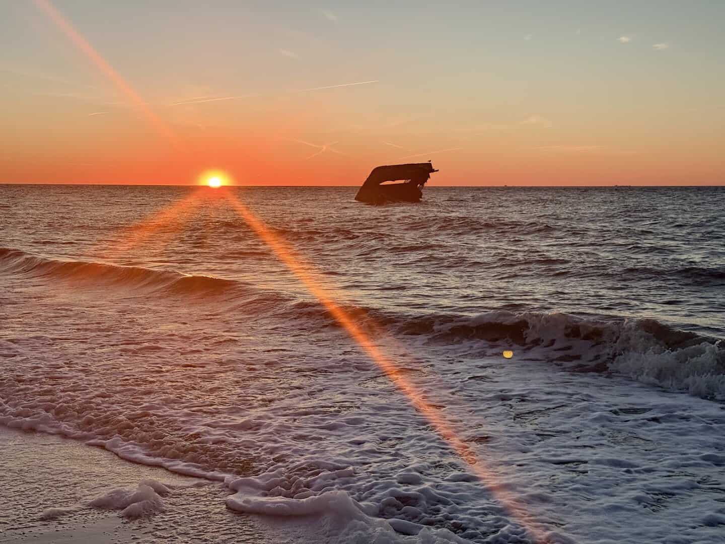 The concrete shipwreck silhouetted at sunset off Sunset Beach, Cape May, New Jersey