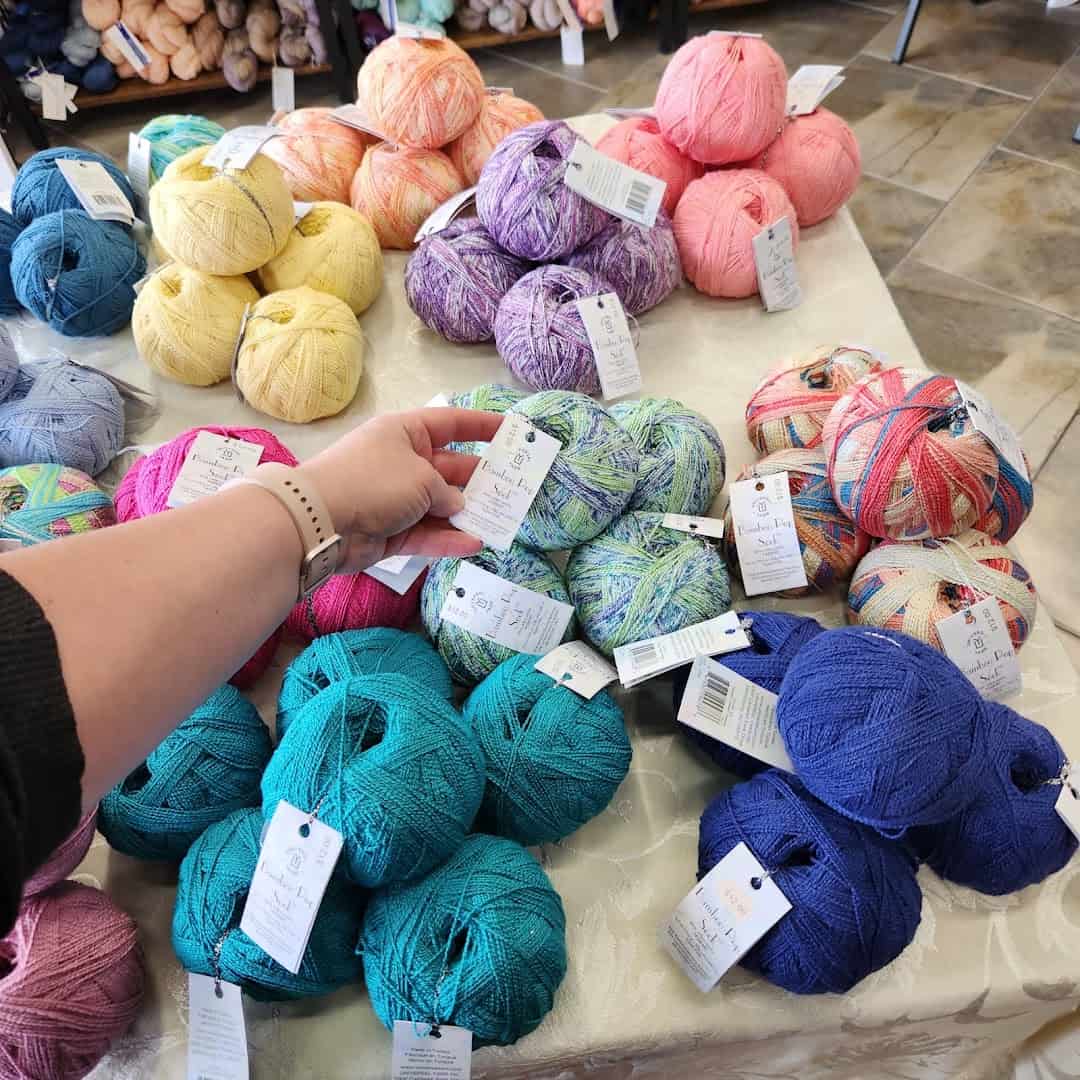 A table piled with colorful yarn at Lone Star Yarn in Bedford, Texas
