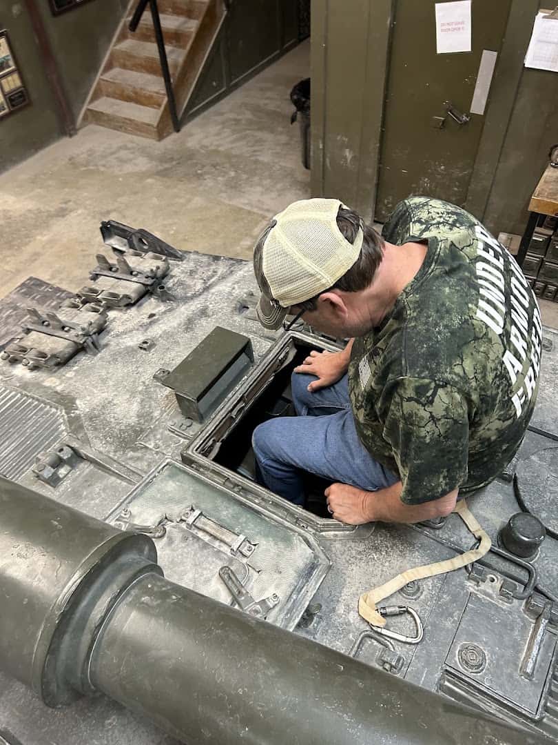 Driver seated in the hatch of a tank at DriveTanks in Uvalde, Texas