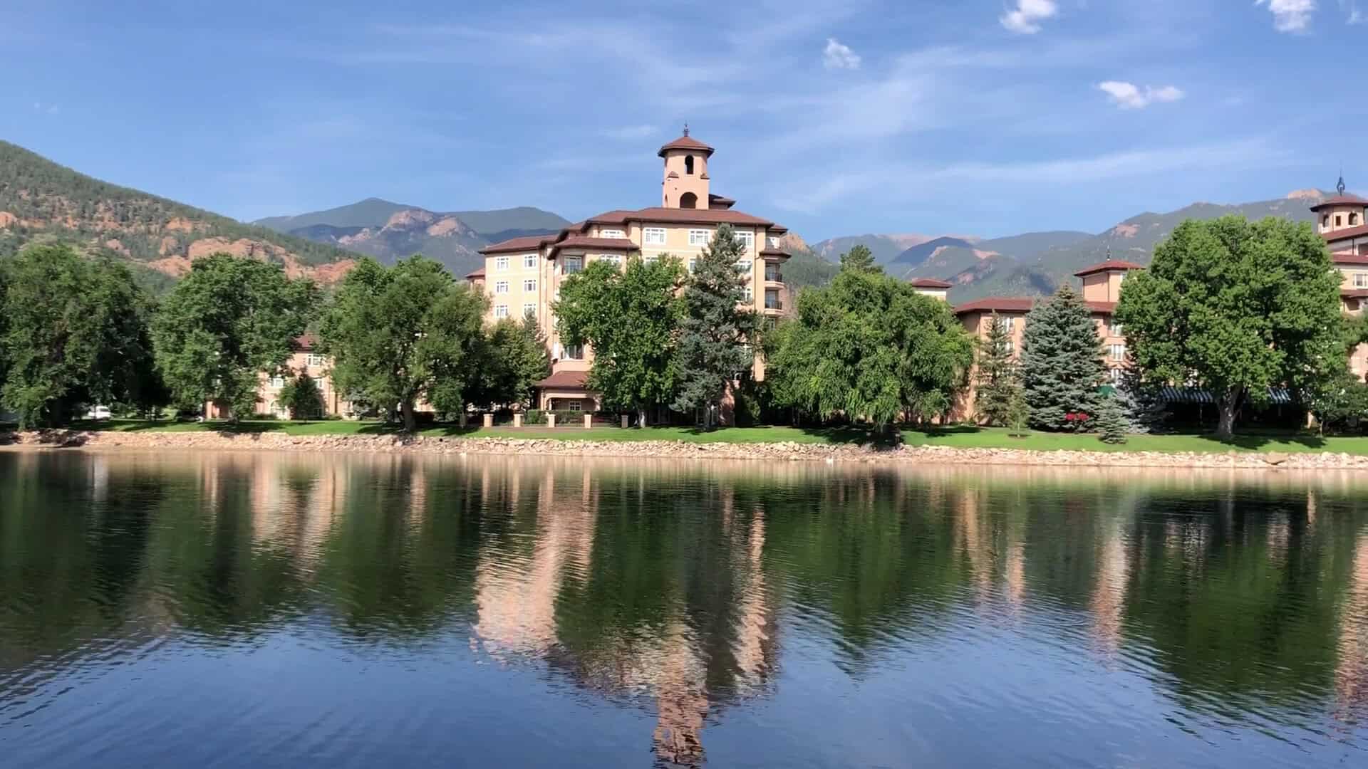 The Broadmoor resort reflected in its lake beneath Cheyenne Mountain in Colorado Springs, Colorado