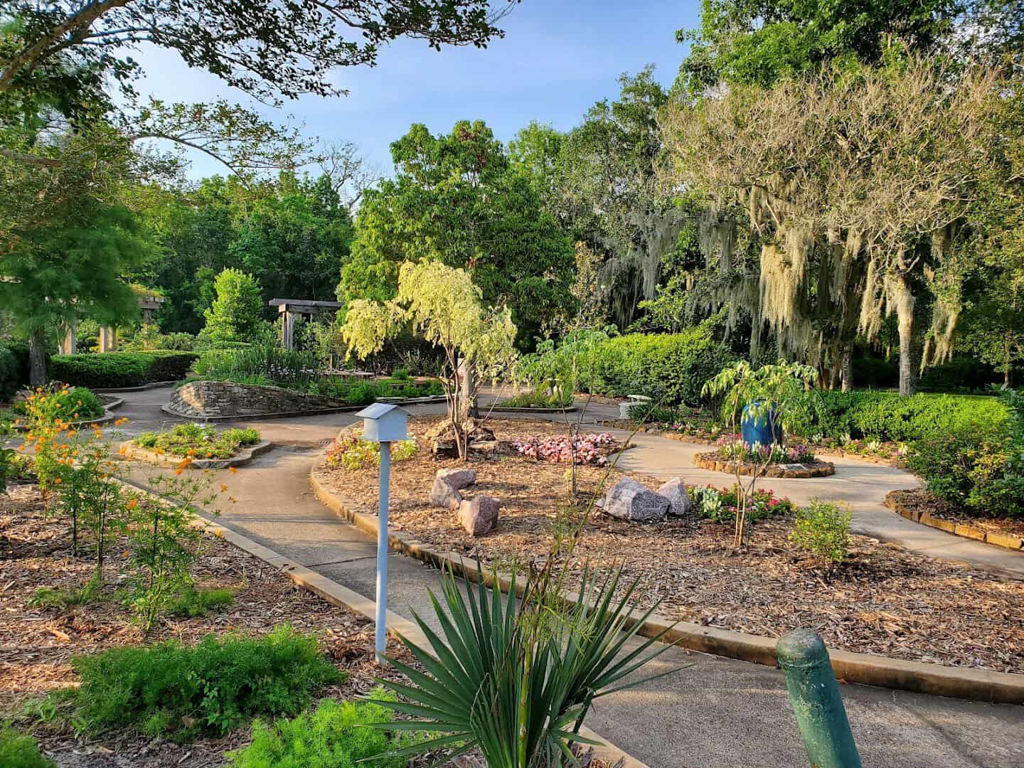 Themed garden beds and winding paths at Beaumont Botanical Gardens