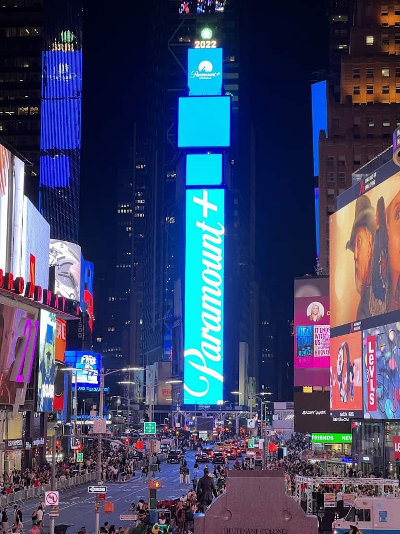 Times Square glowing with neon billboards at night, Manhattan, New York