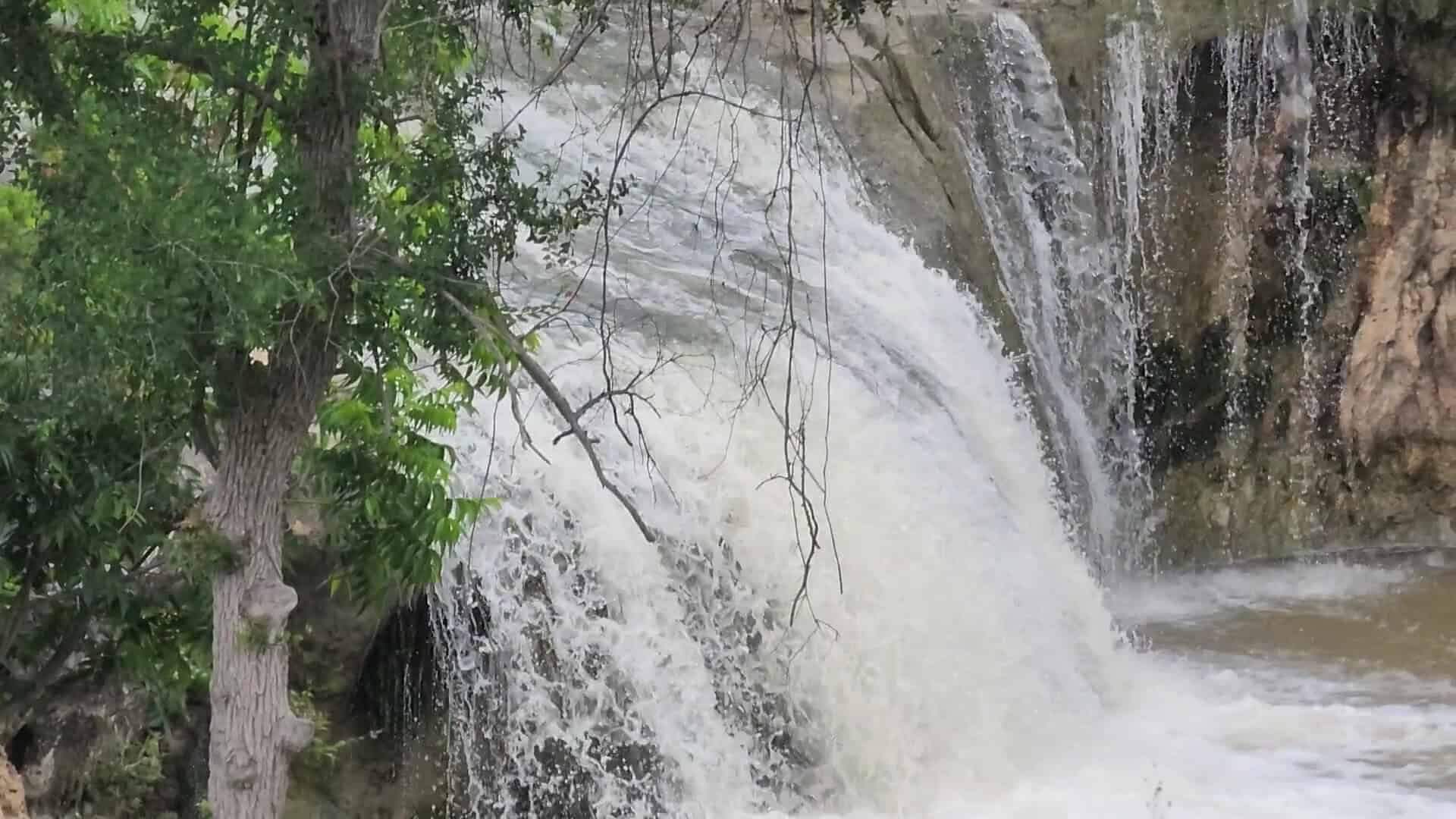 Close-up of Tonkawa Falls rushing over the limestone lip after a rain in Crawford, Texas