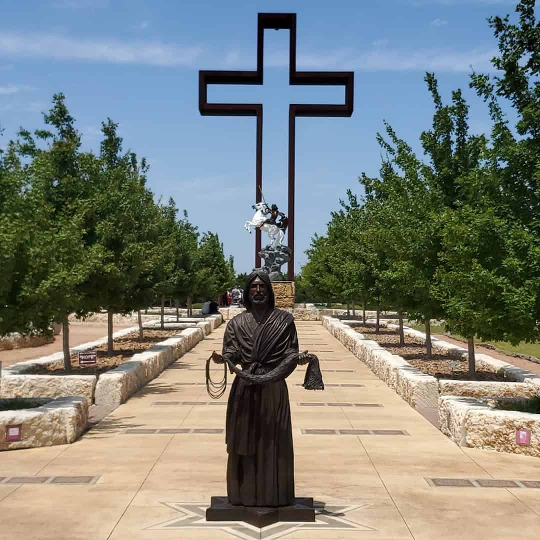 Tree lined path leading to the Empty Cross at the Coming King Sculpture Prayer Garden in Kerrville