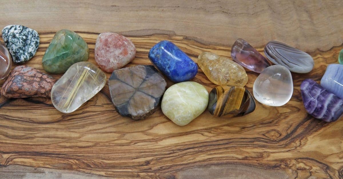 Assorted tumbled stones on a wood board from Nature's Treasures in Austin