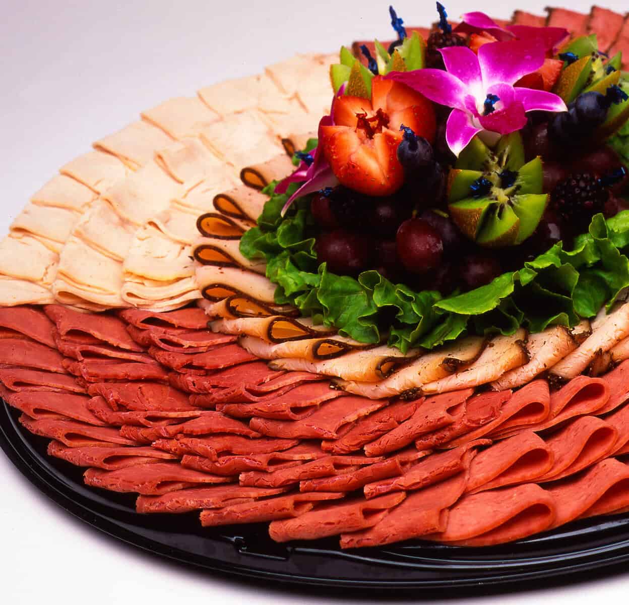 Sliced turkey and deli meat catering platter at Kenny & Ziggy's in Houston